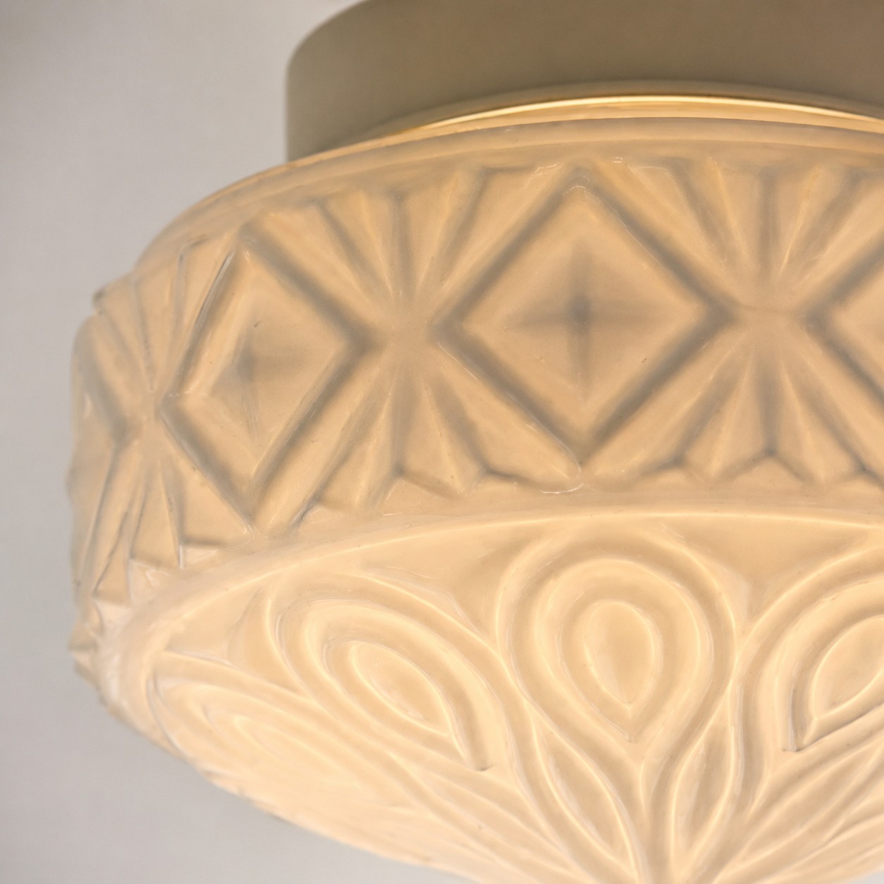 Warm close-up of embossed glass ceiling light pattern