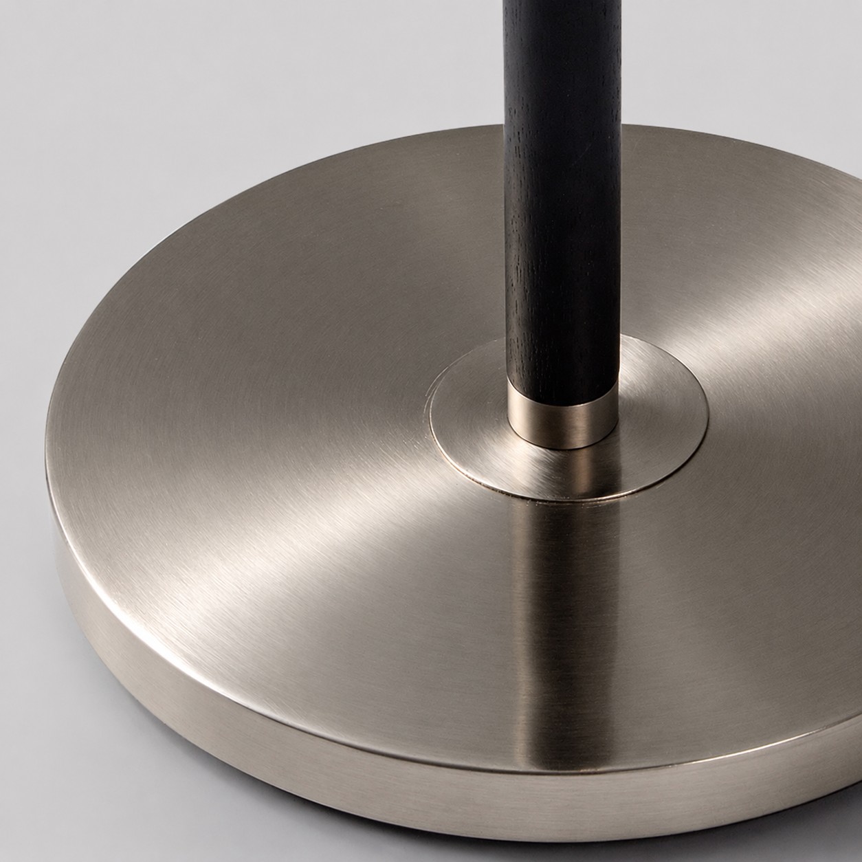 Circular brushed chrome base detail for a Bauhaus floor lamp
