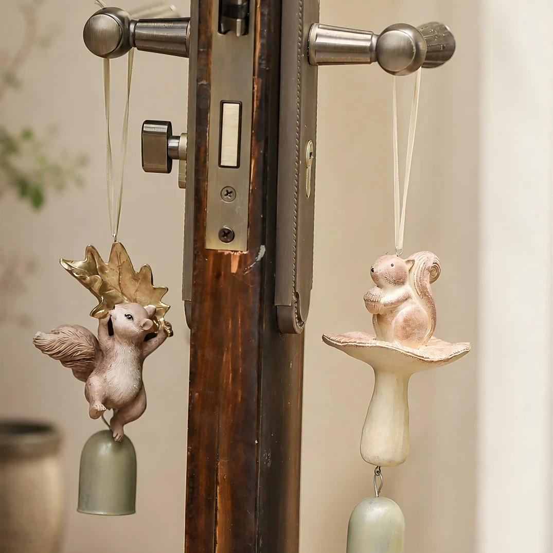 Two warm ivory squirrel wind chime styles hanging on a handle