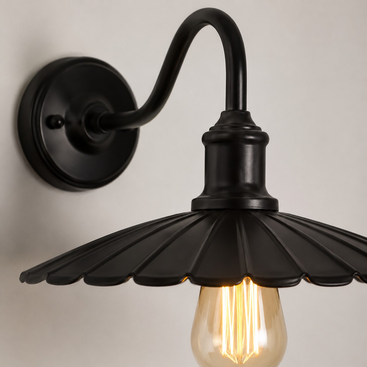 Black wall sconce shade and arm detail