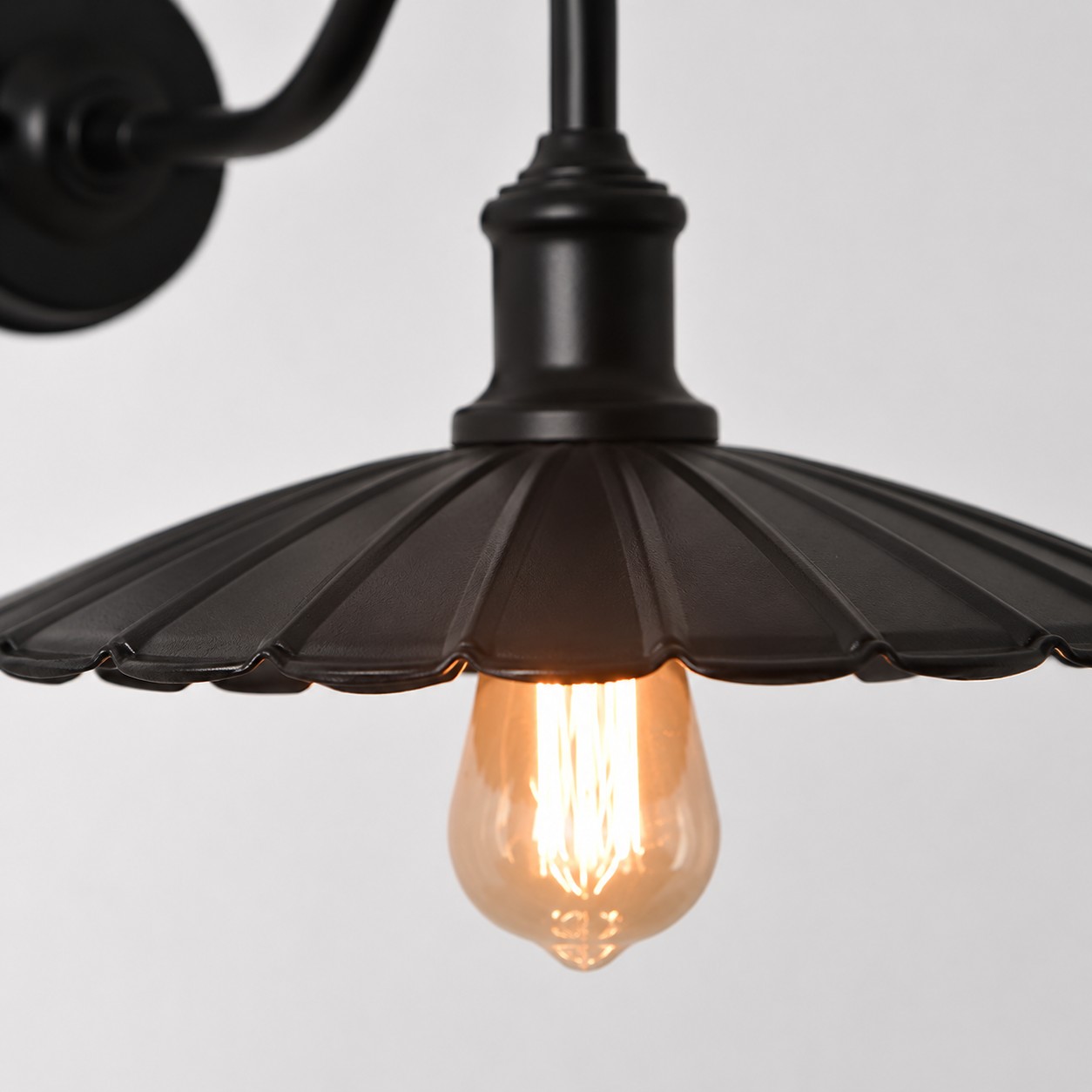Antique Bronze wall sconce shade and arm detail