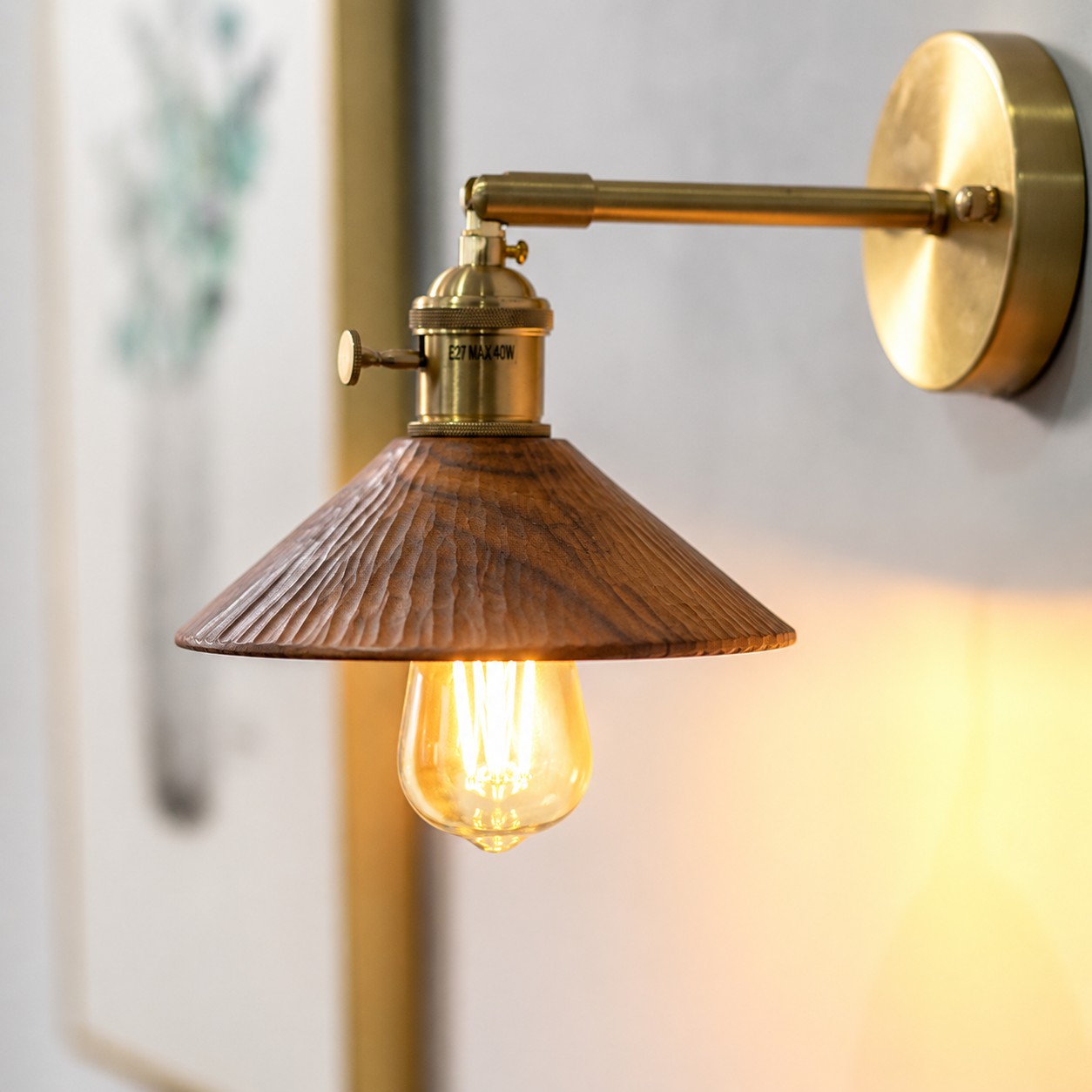 Wood and brass wall sconce casting warm light above a shelf