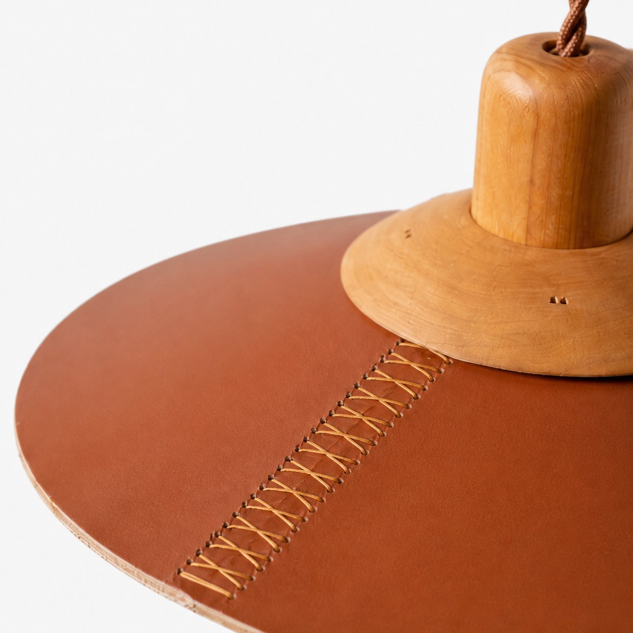 Brown leather shade with hand cross-stitching