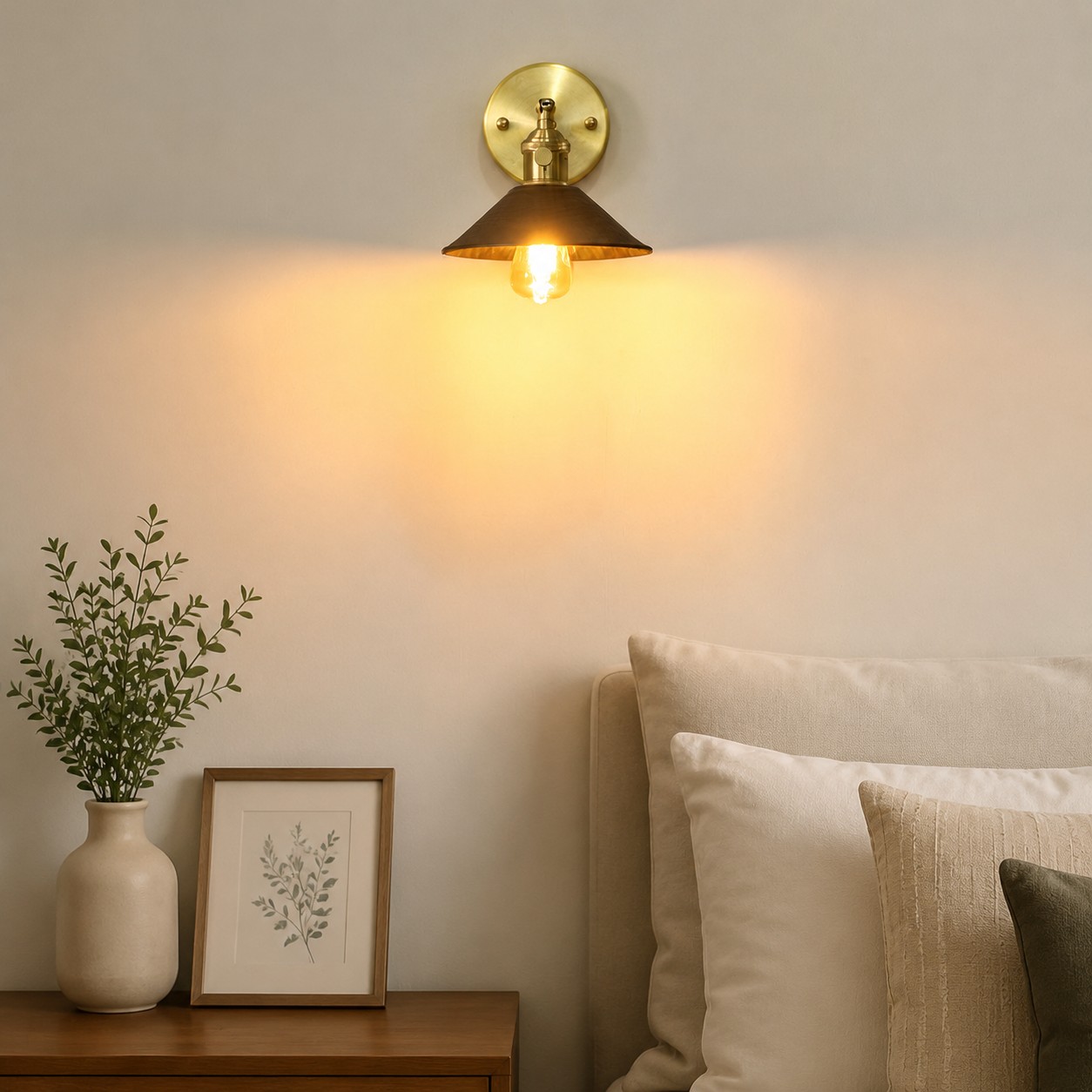 Wood and brass wall sconce installed in a warm bedroom