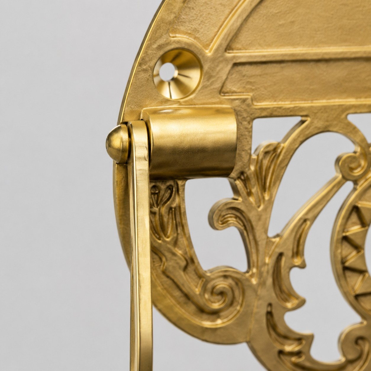 Close detail of brass side bracket and hinge